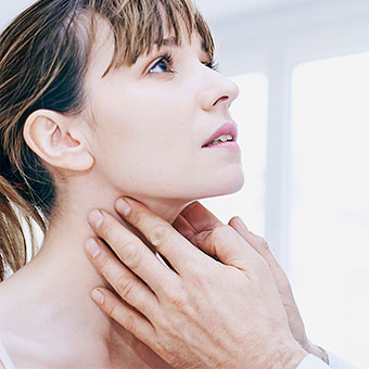 Woman touching neck