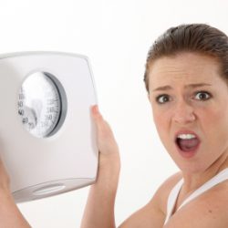 Frustrated woman with scale