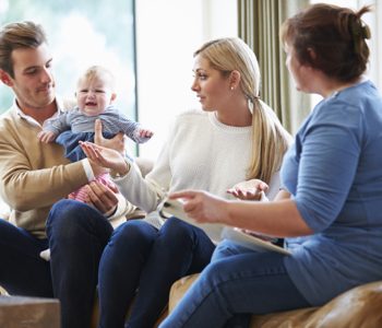 Social Worker Visiting Family With Young Baby Social Worker Visiting Family With Young Baby